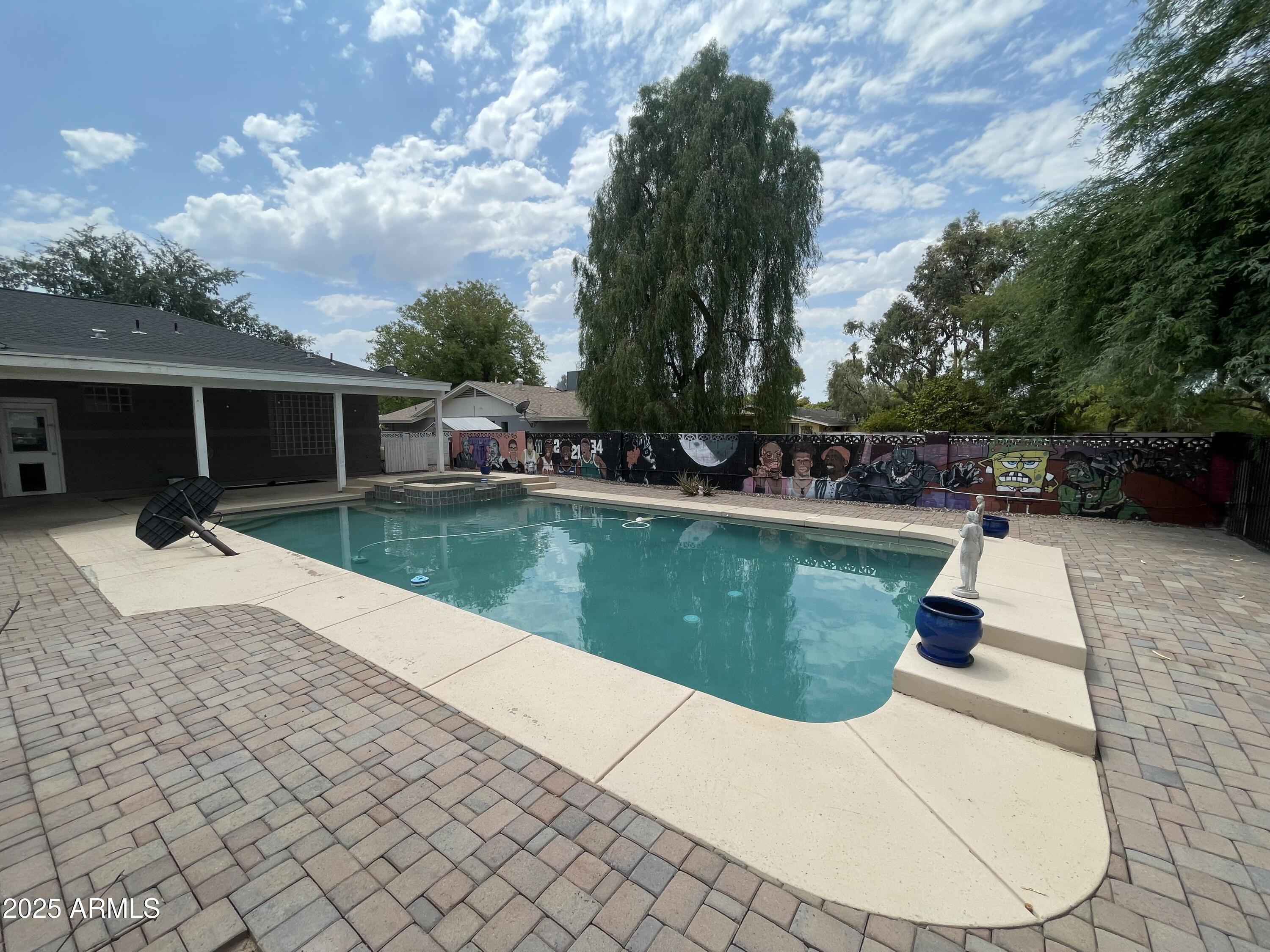 702 West Why Worry Lane Phoenix, AZ 85021 - Photo 39 of 46 a swimming pool with outdoor seating and barbeque oven