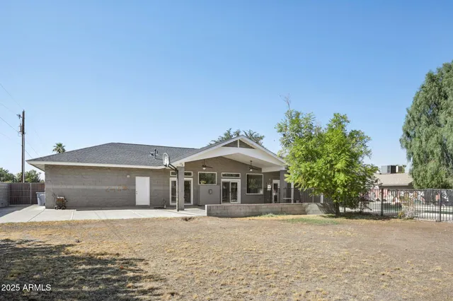 a swimming pool with outdoor seating and barbeque oven