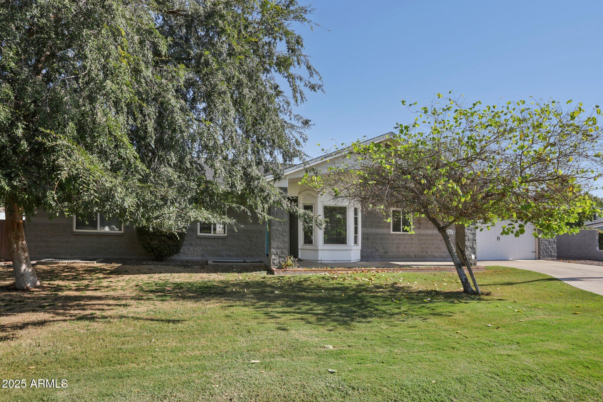 702 West Why Worry Lane Phoenix, AZ 85021 - Photo 3 of 46 a front view of a house with a garden