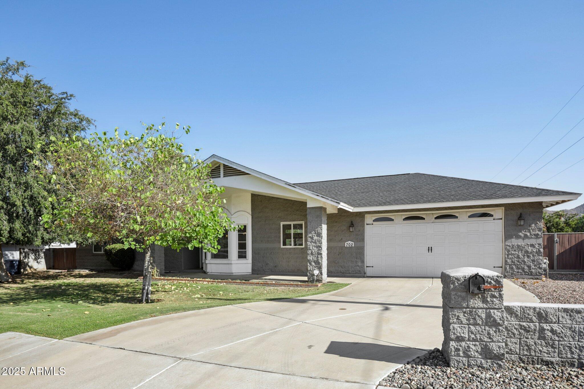 702 West Why Worry Lane Phoenix, AZ 85021 - Photo 4 of 46 front view of a house with a yard