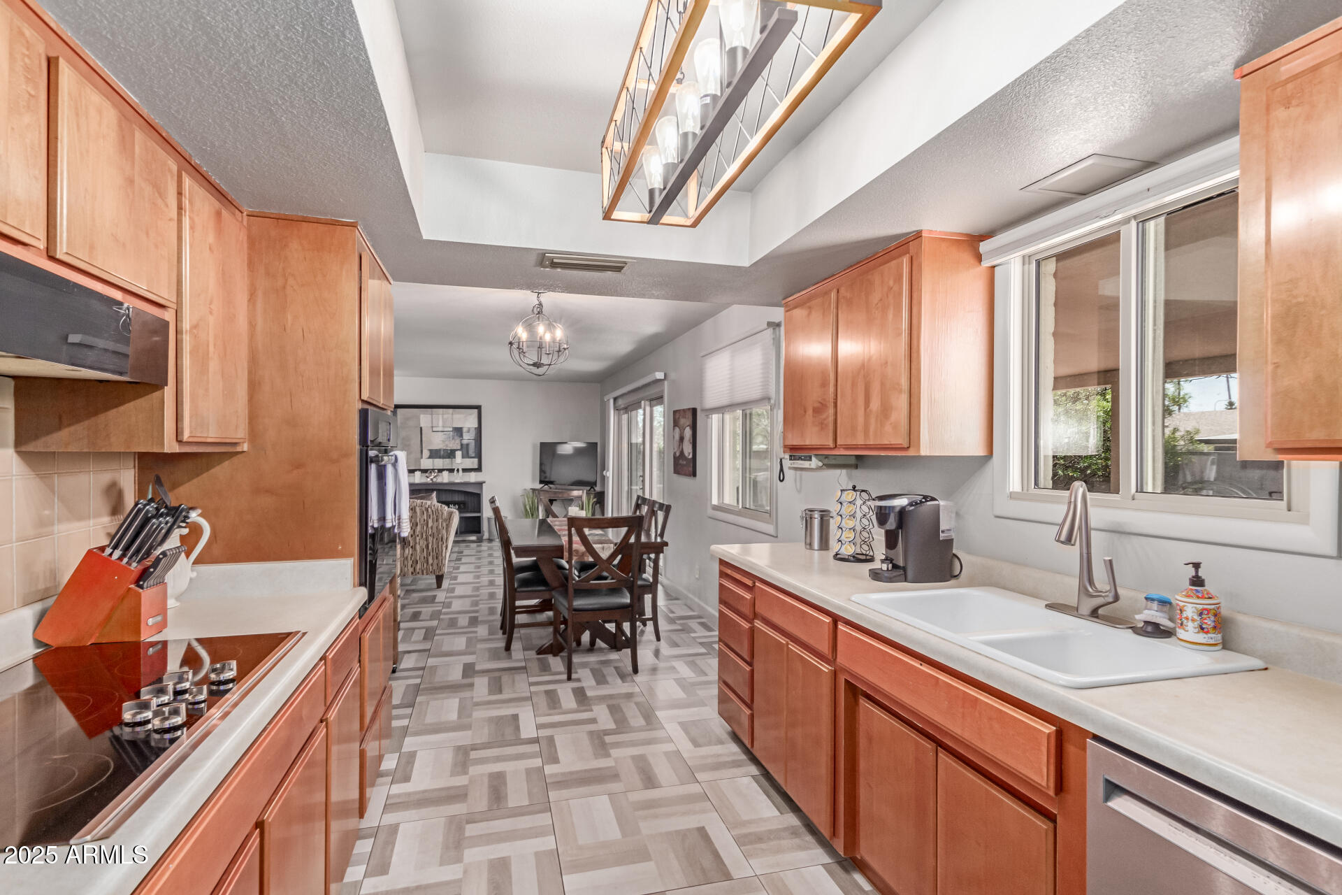 2716 South Terrace Road Tempe, AZ 85282 - Photo 11 of 32 a large kitchen with stainless steel appliances a stove a sink dishwasher and cabinets