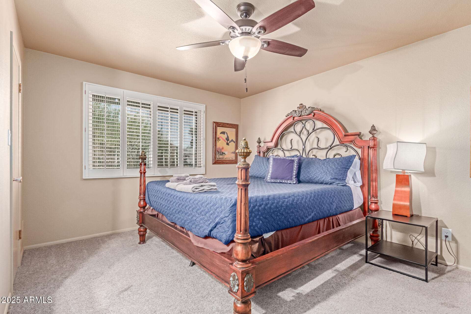 2716 South Terrace Road Tempe, AZ 85282 - Photo 12 of 32 a bedroom with a bed and a chandelier