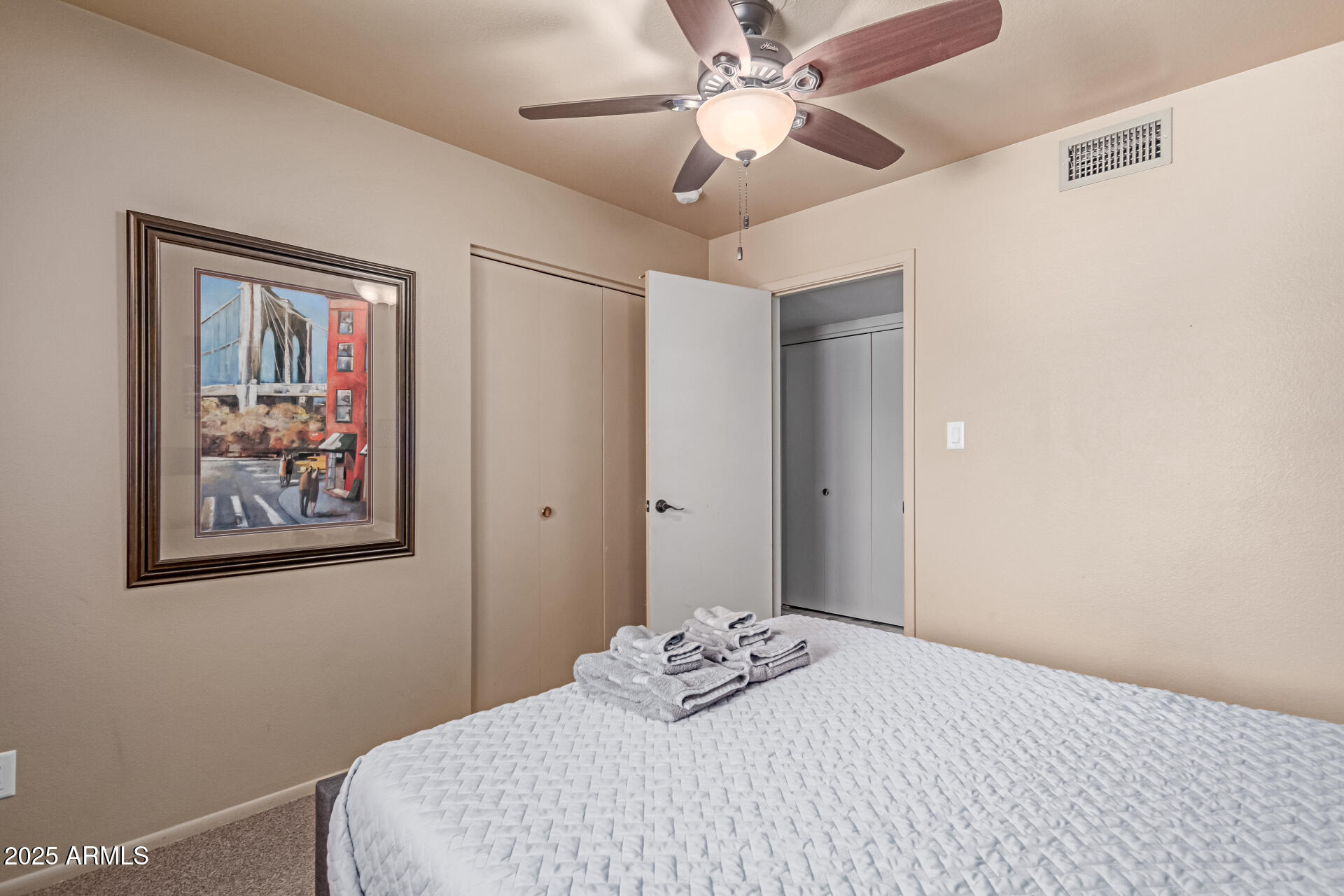 2716 South Terrace Road Tempe, AZ 85282 - Photo 19 of 32 a bedroom with a large bed and a chandelier