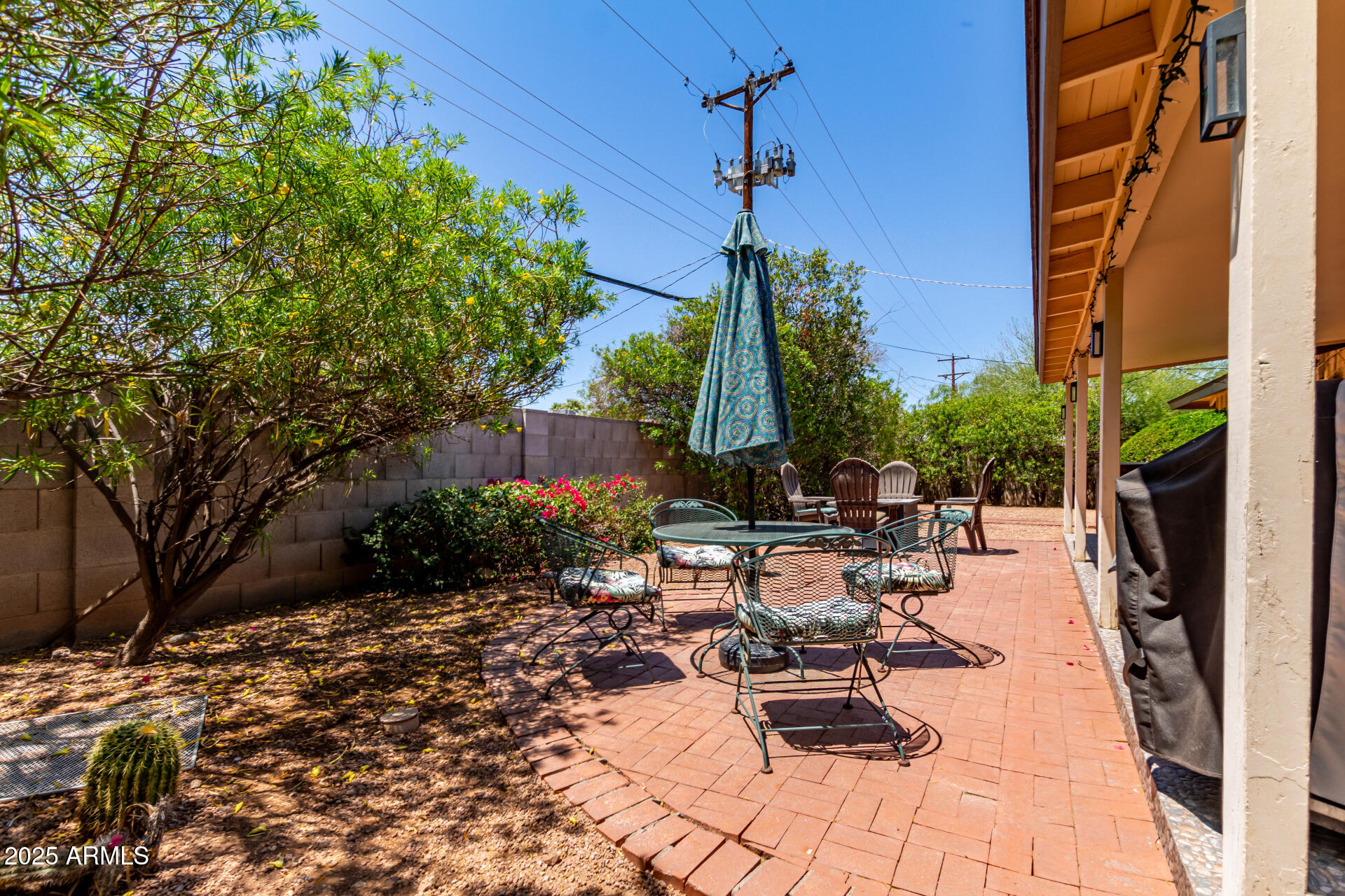 2716 South Terrace Road Tempe, AZ 85282 - Photo 29 of 32 a view of a patio with a table and chairs under an umbrella with potted plants