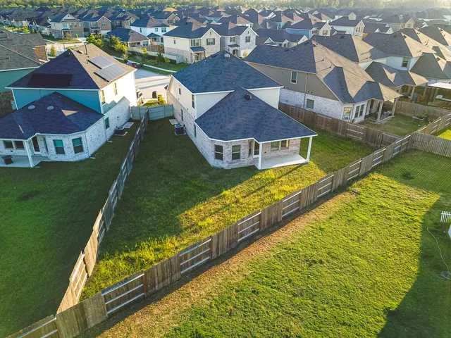 an aerial view of residential houses with outdoor space