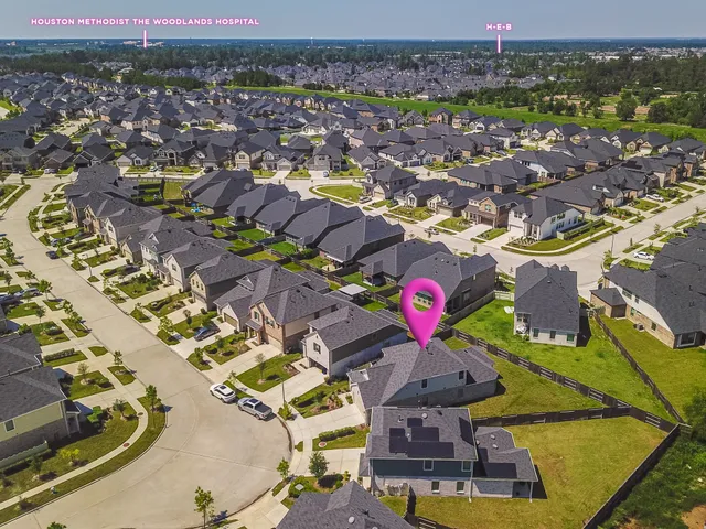 an aerial view of residential houses with outdoor space