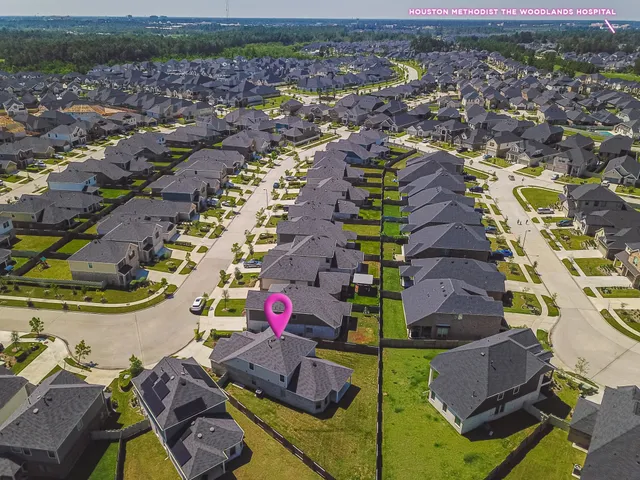 an aerial view of residential houses with outdoor space