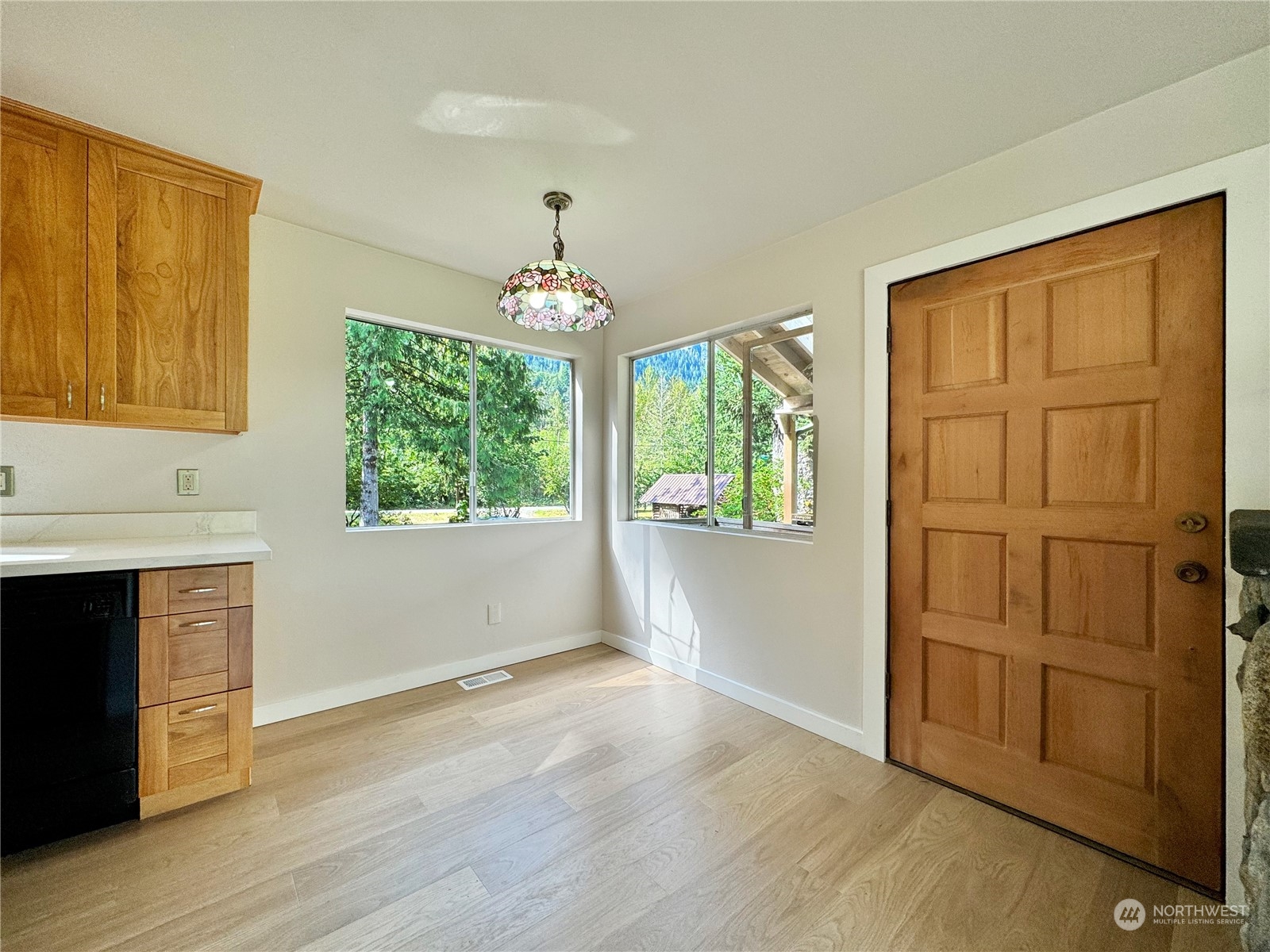 51603 South Riverside Road Gold Bar, WA 98251 - Photo 12 of 38 an empty room with wooden floor cabinet and windows