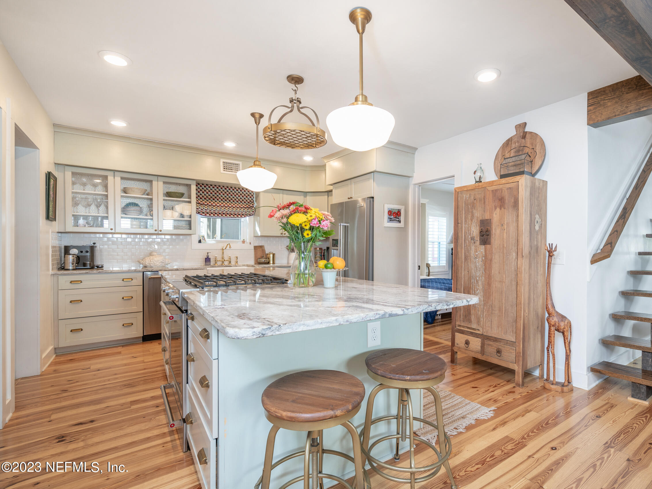 124 South 5th Street Fernandina Beach, FL 32034 - Photo 15 of 60 a kitchen with stainless steel appliances kitchen island granite countertop a stove a sink and a refrigerator