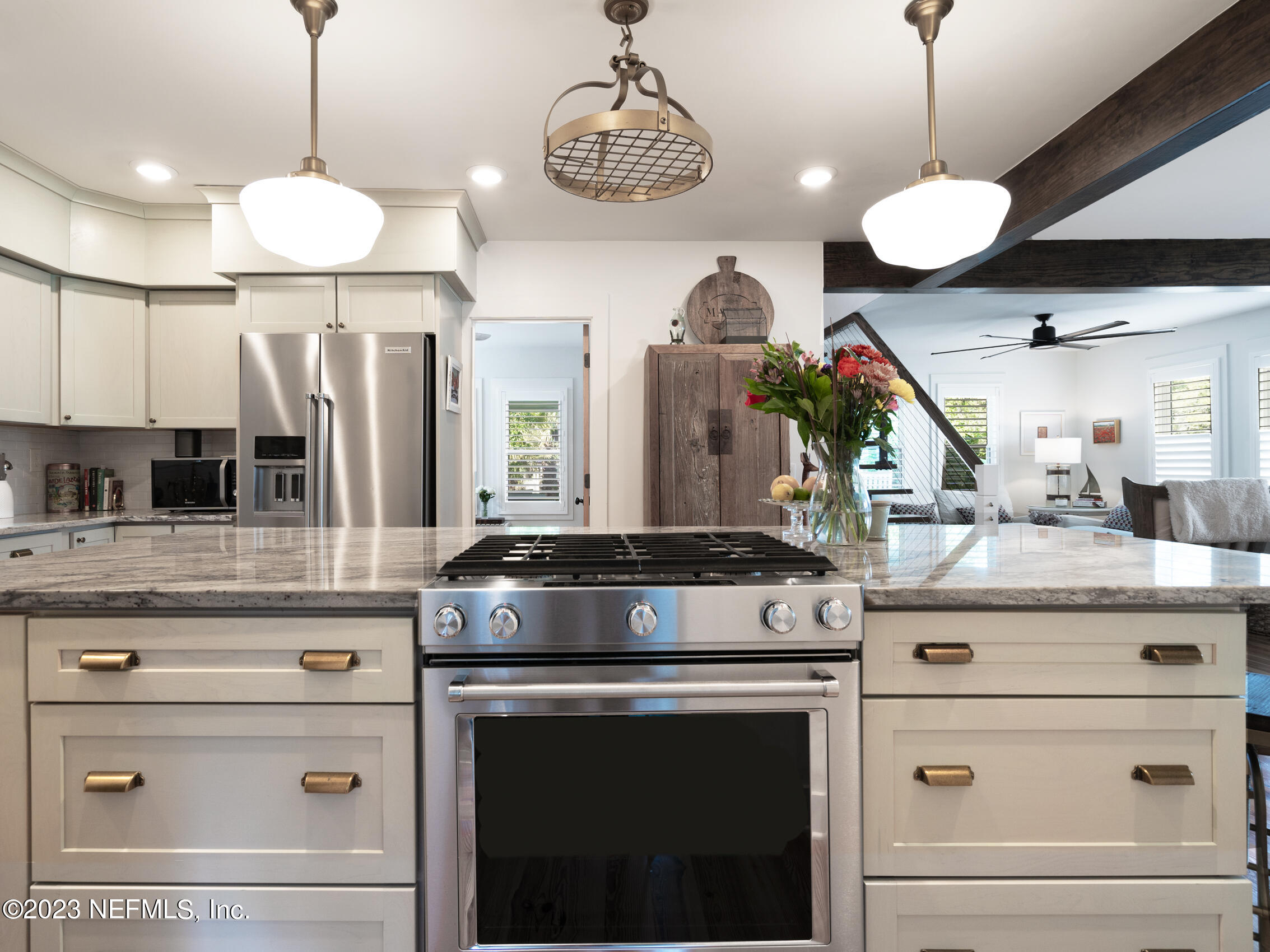 124 South 5th Street Fernandina Beach, FL 32034 - Photo 16 of 60 a kitchen with a stove and a chandelier