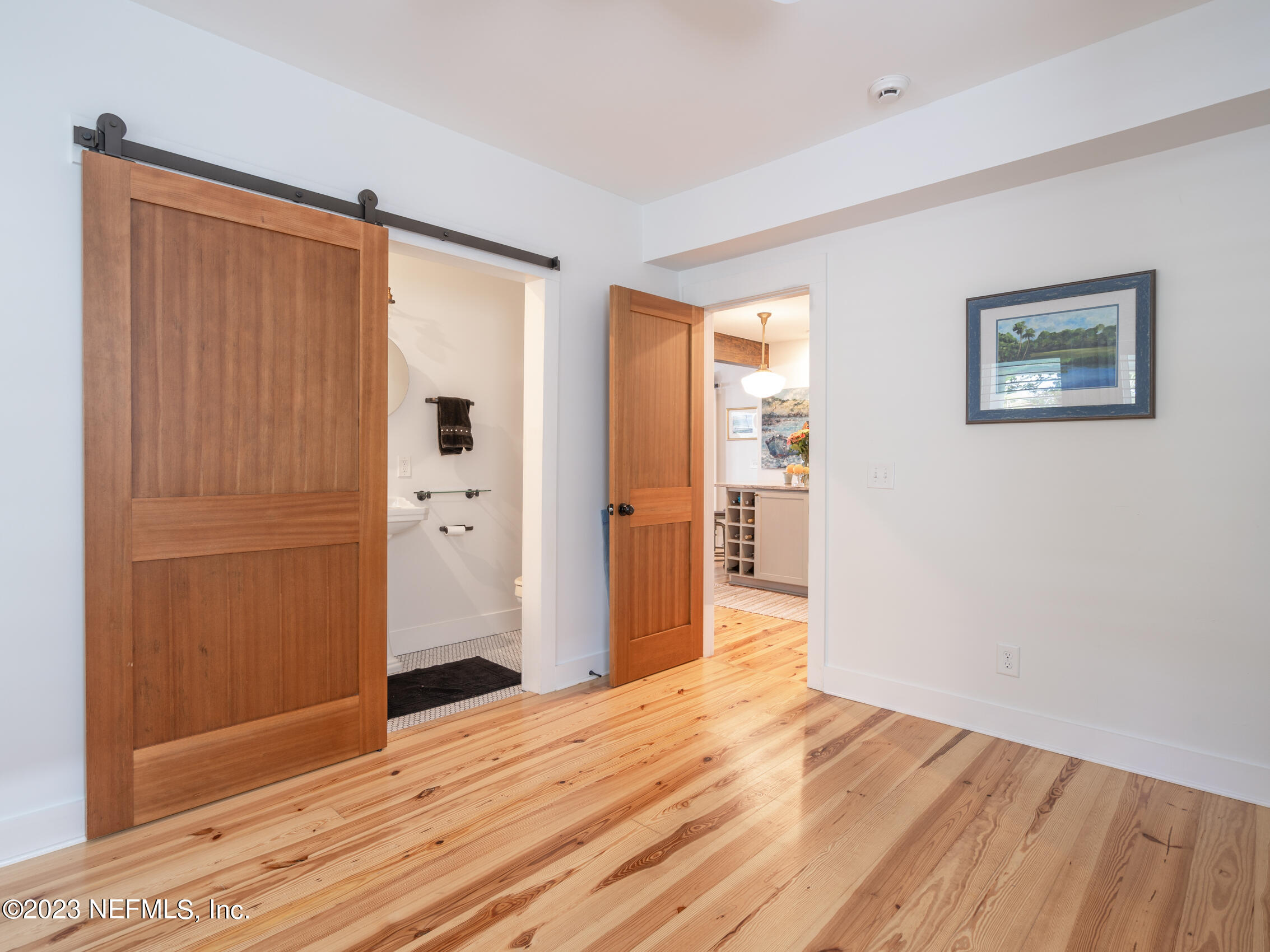124 South 5th Street Fernandina Beach, FL 32034 - Photo 23 of 60 an empty room with wooden floor and windows