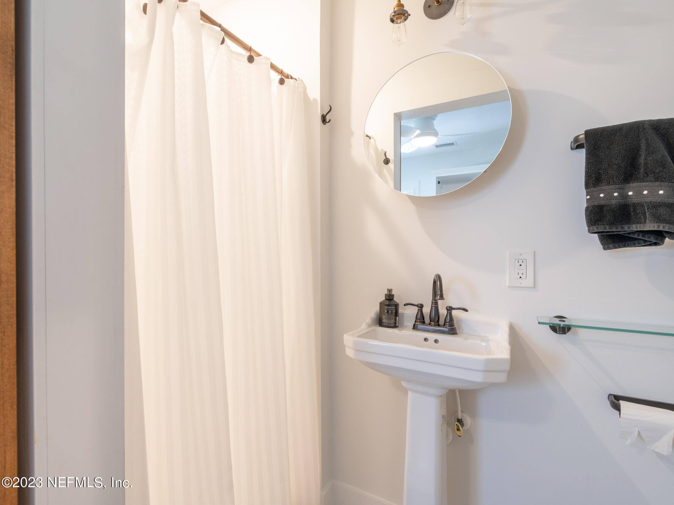 124 South 5th Street Fernandina Beach, FL 32034 - Photo 24 of 60 a bathroom with a sink a mirror and vanity