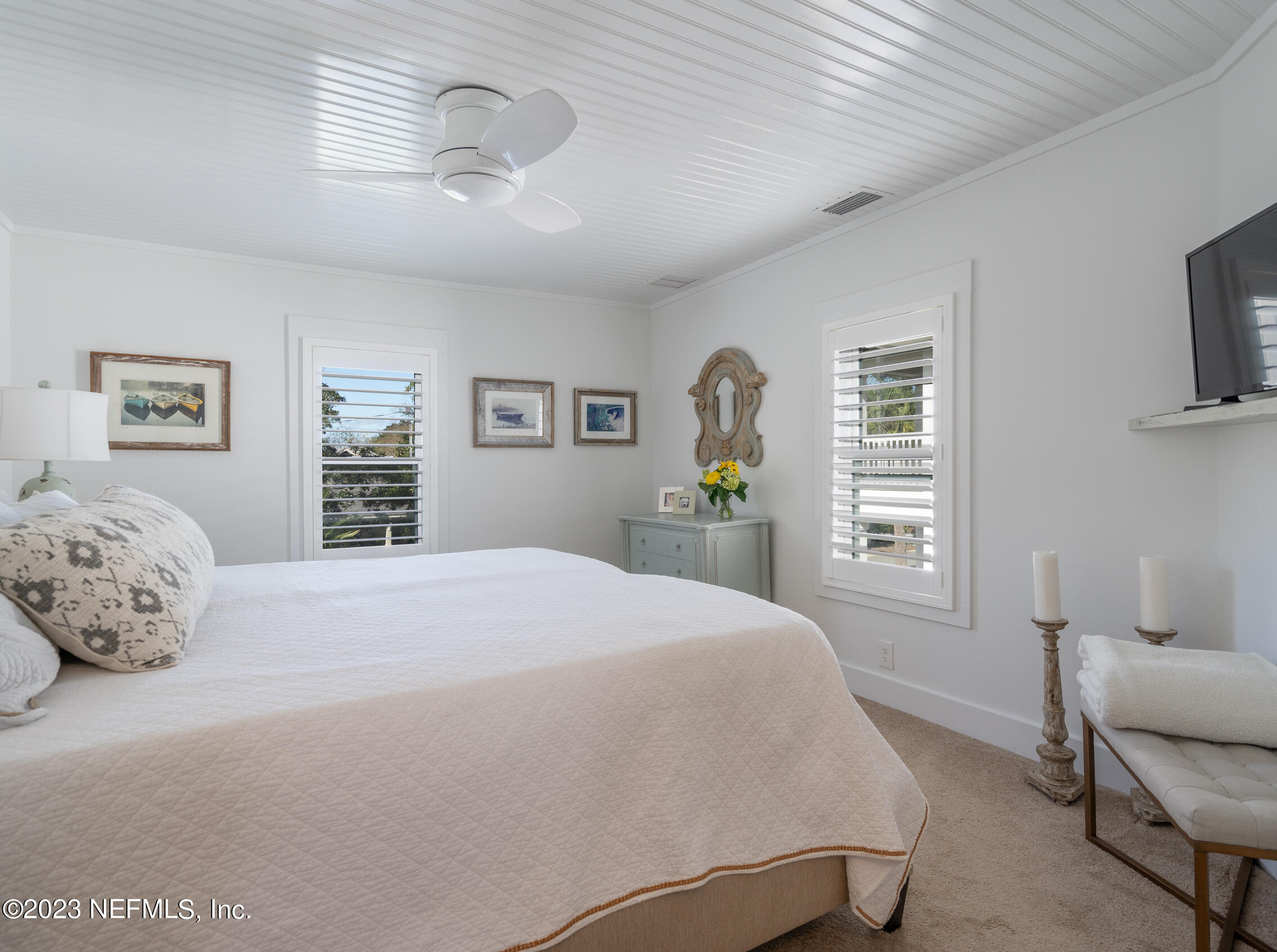 124 South 5th Street Fernandina Beach, FL 32034 - Photo 27 of 60 a bedroom with a bed and a couch