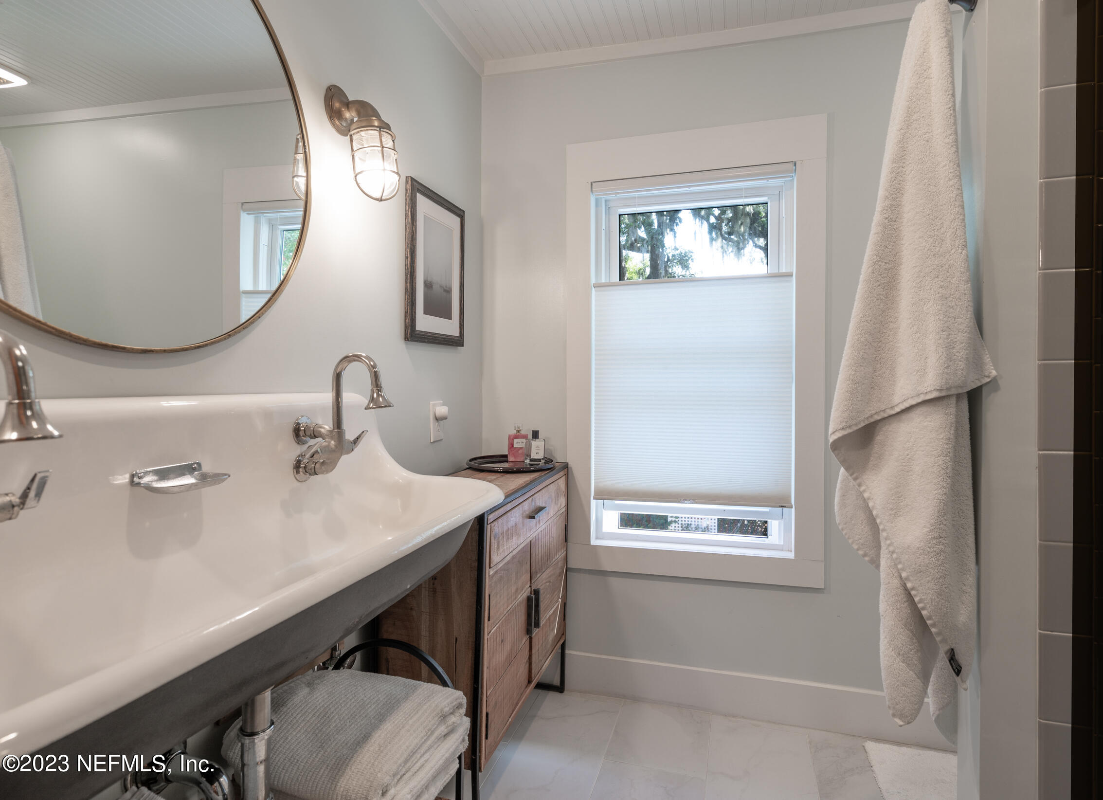 124 South 5th Street Fernandina Beach, FL 32034 - Photo 30 of 60 a bathroom with a sink mirror and a window