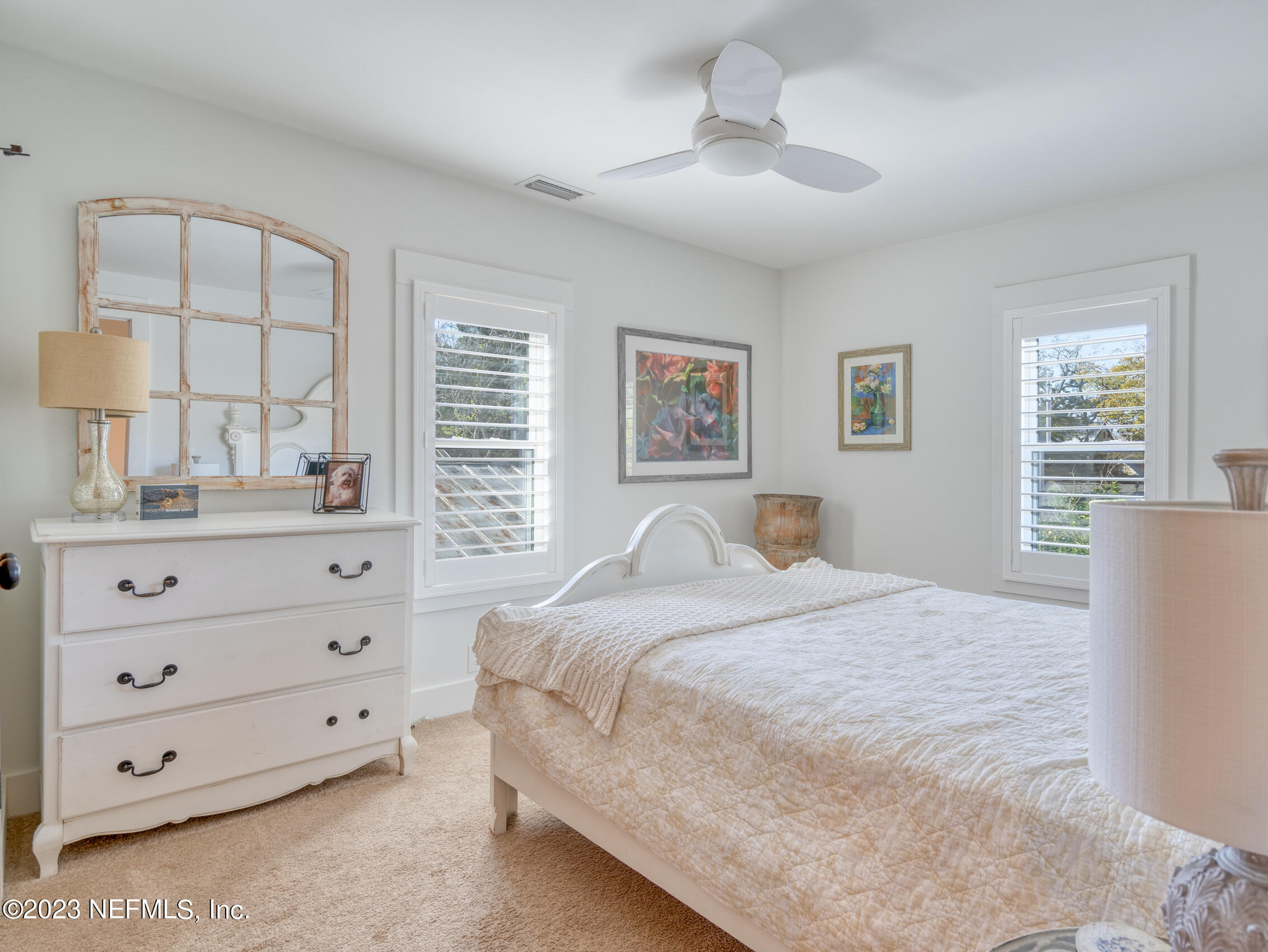 124 South 5th Street Fernandina Beach, FL 32034 - Photo 34 of 60 a bedroom with a bed and a dresser