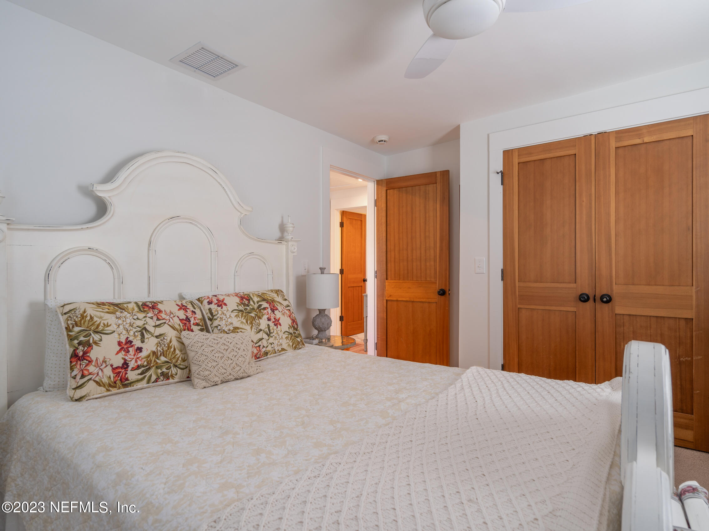 124 South 5th Street Fernandina Beach, FL 32034 - Photo 35 of 60 a bedroom with a large bed and a couch