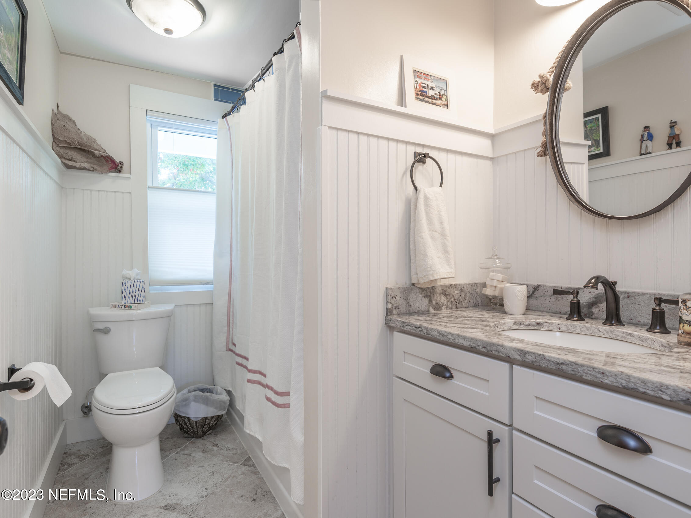 124 South 5th Street Fernandina Beach, FL 32034 - Photo 36 of 60 a bathroom with a granite countertop toilet sink and mirror