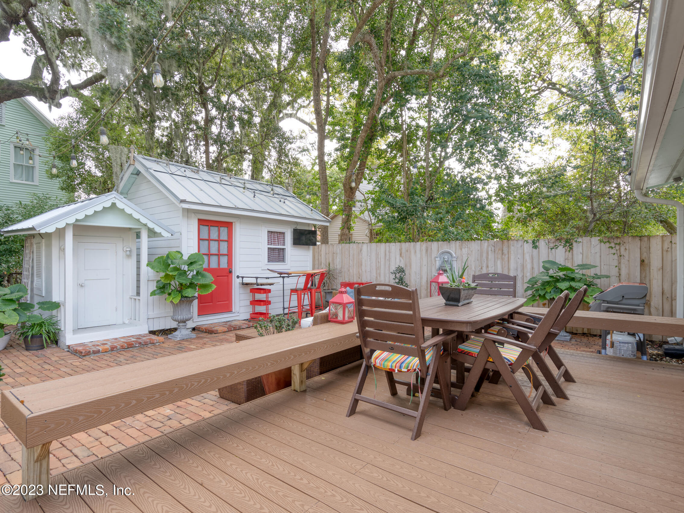 124 South 5th Street Fernandina Beach, FL 32034 - Photo 38 of 60 a view of a dinning table and chairs in patio of the house