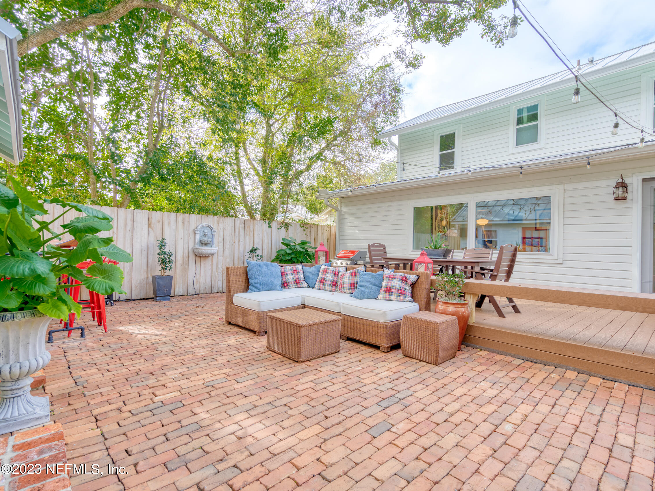 124 South 5th Street Fernandina Beach, FL 32034 - Photo 42 of 60 a view of a patio with table and chairs potted plants and a large tree