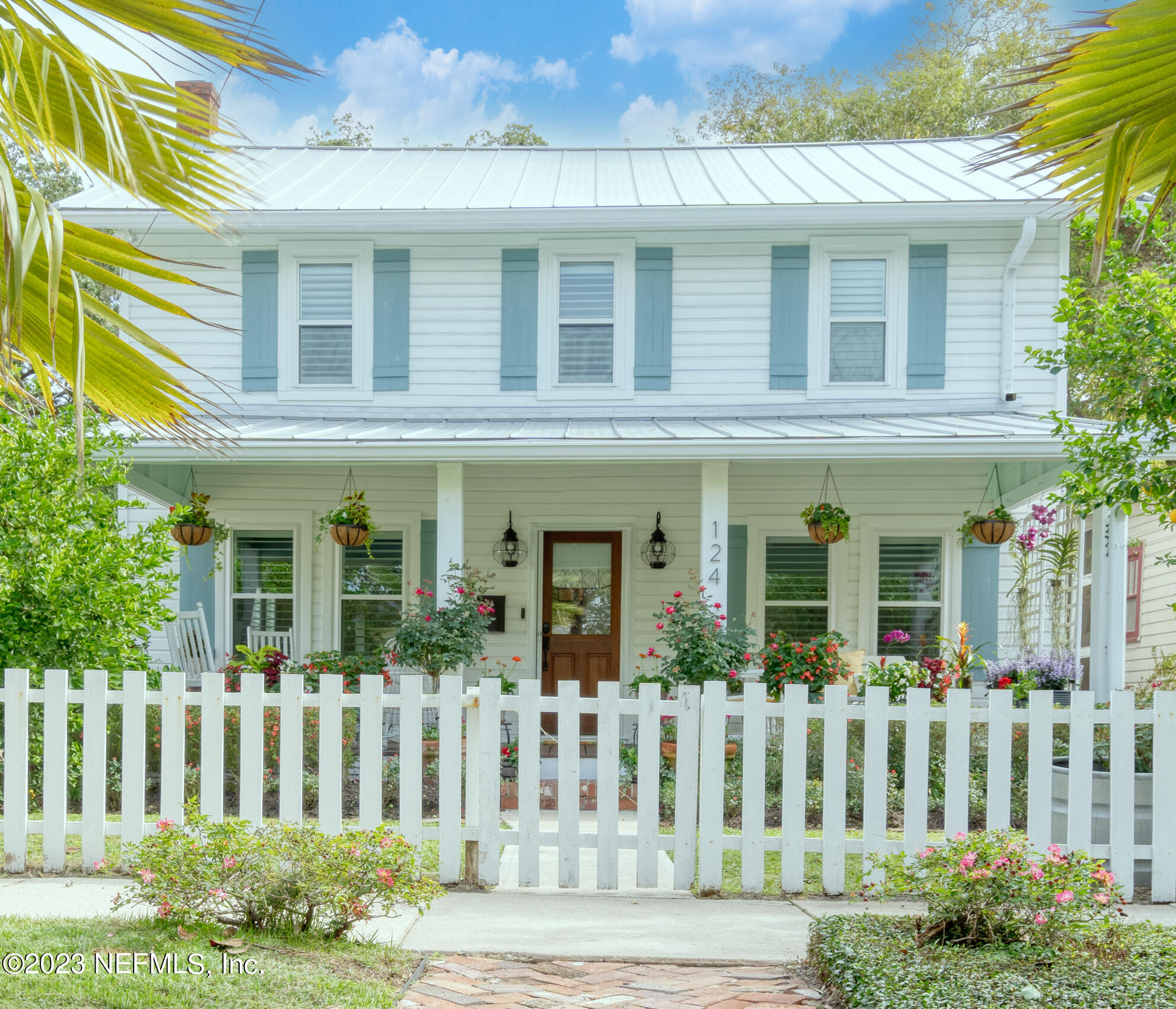 124 South 5th Street Fernandina Beach, FL 32034 - Photo 47 of 60 a front view of a house with a lots of flower plants