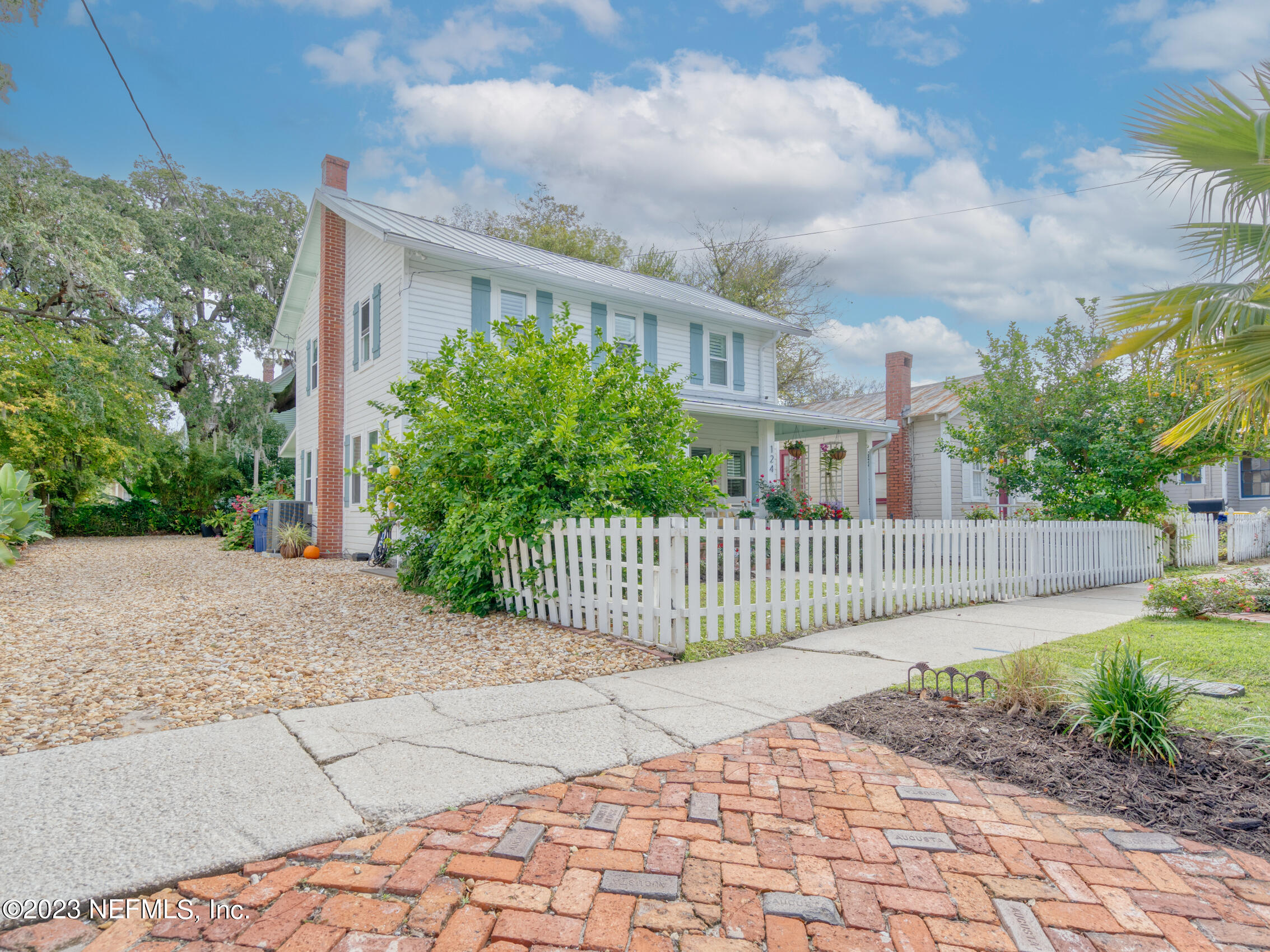 124 South 5th Street Fernandina Beach, FL 32034 - Photo 49 of 60 a view of a house with a small yard and plants