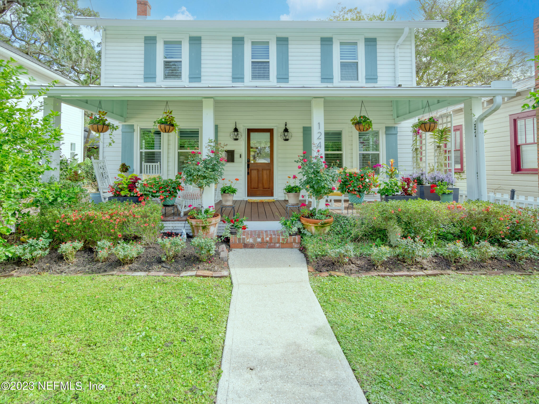 124 South 5th Street Fernandina Beach, FL 32034 - Photo 53 of 60 a front view of a brick house with a yard