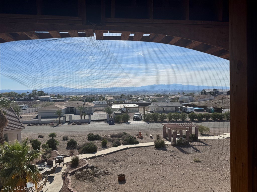 622 North Parawan Street Henderson, NV 89015 - Photo 1 of 3 Framed by a rustic archway, panoramic desert vistas stretch towards distant mountains and the city lights.