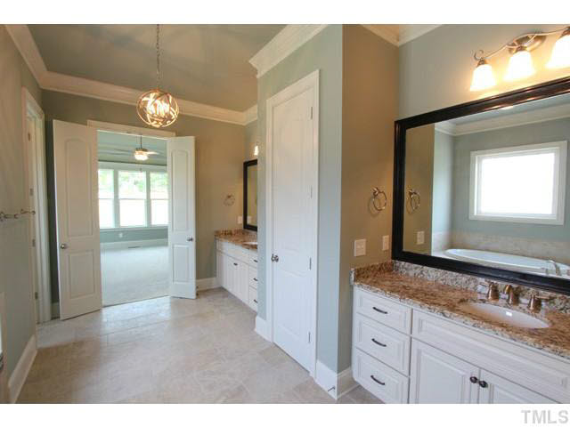 3208 Bryant Falls Court Raleigh, NC 27613 - Photo 11 of 25 a spacious bathroom with a granite countertop sink mirror and a