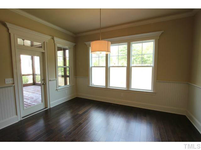 3208 Bryant Falls Court Raleigh, NC 27613 - Photo 6 of 25 a view of an empty room with wooden floor and a window