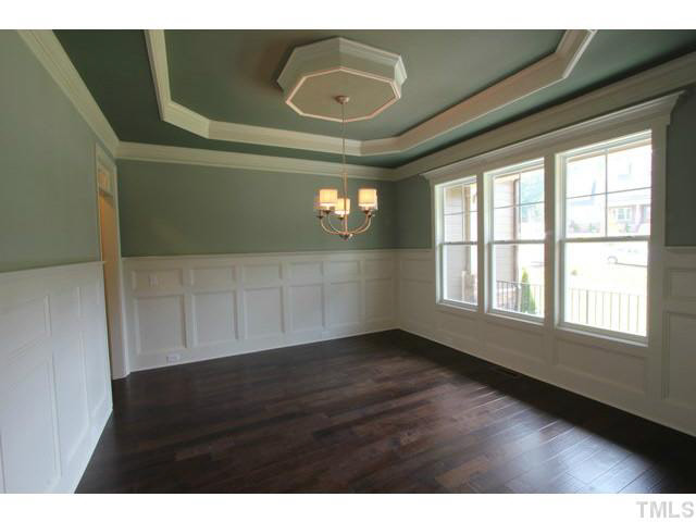 3208 Bryant Falls Court Raleigh, NC 27613 - Photo 7 of 25 a view of an empty room with wooden floor and a window
