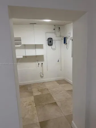 a view of a storage & utility room with racks on the wall
