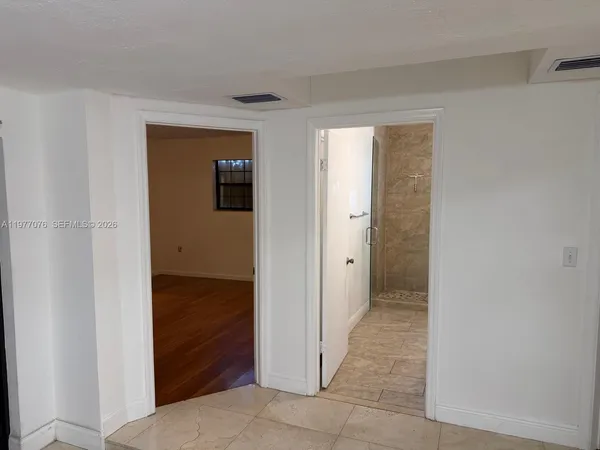 a view of a hallway with wooden shelves
