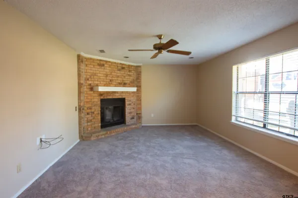 a view of empty room with a fireplace