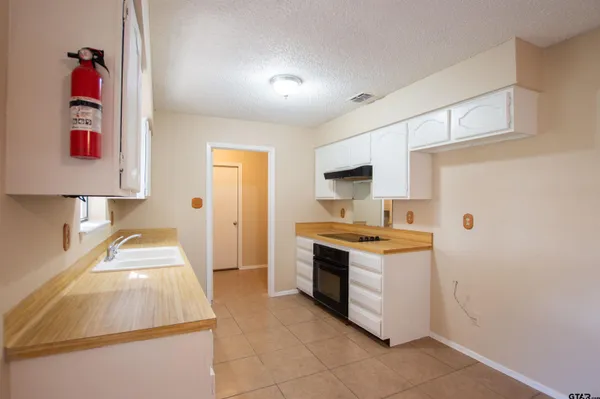 a kitchen with a stove and a refrigerator