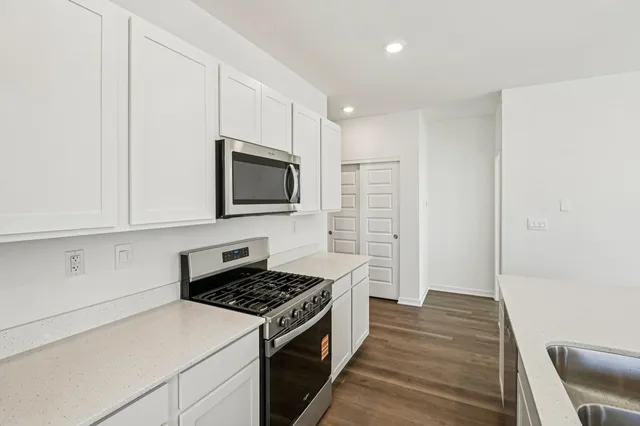 a kitchen with a stove and a microwave