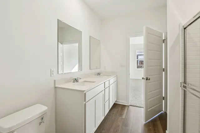 a bathroom with a sink a toilet and a mirror