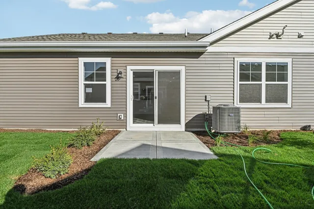 a view of a house with backyard and sitting area