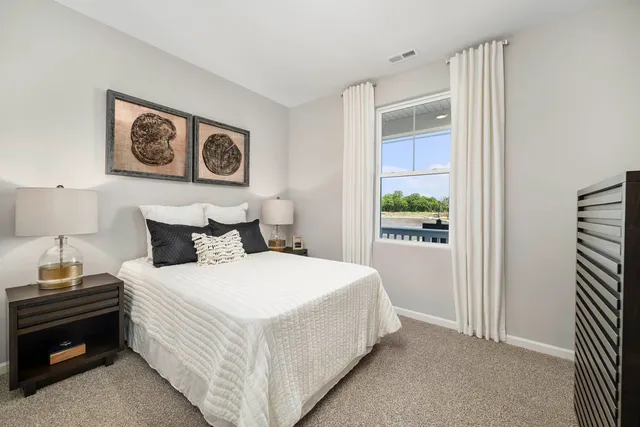 a bedroom with a bed and a window