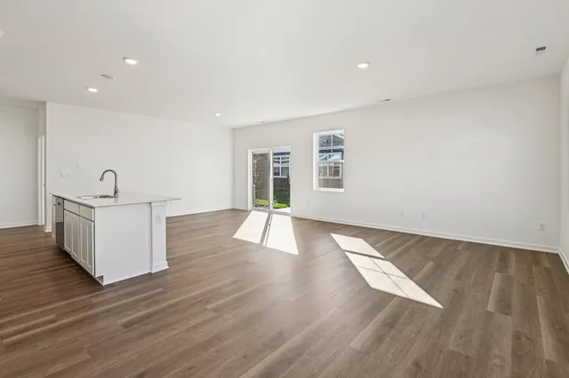 a view of a room with wooden floor and window