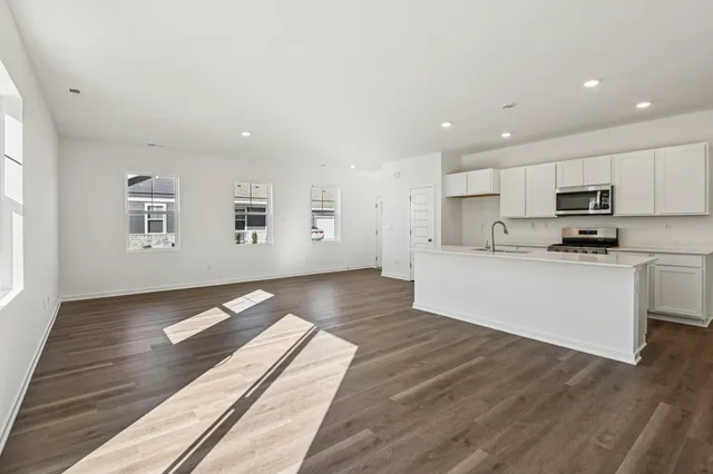 a view of kitchen with microwave and cabinets