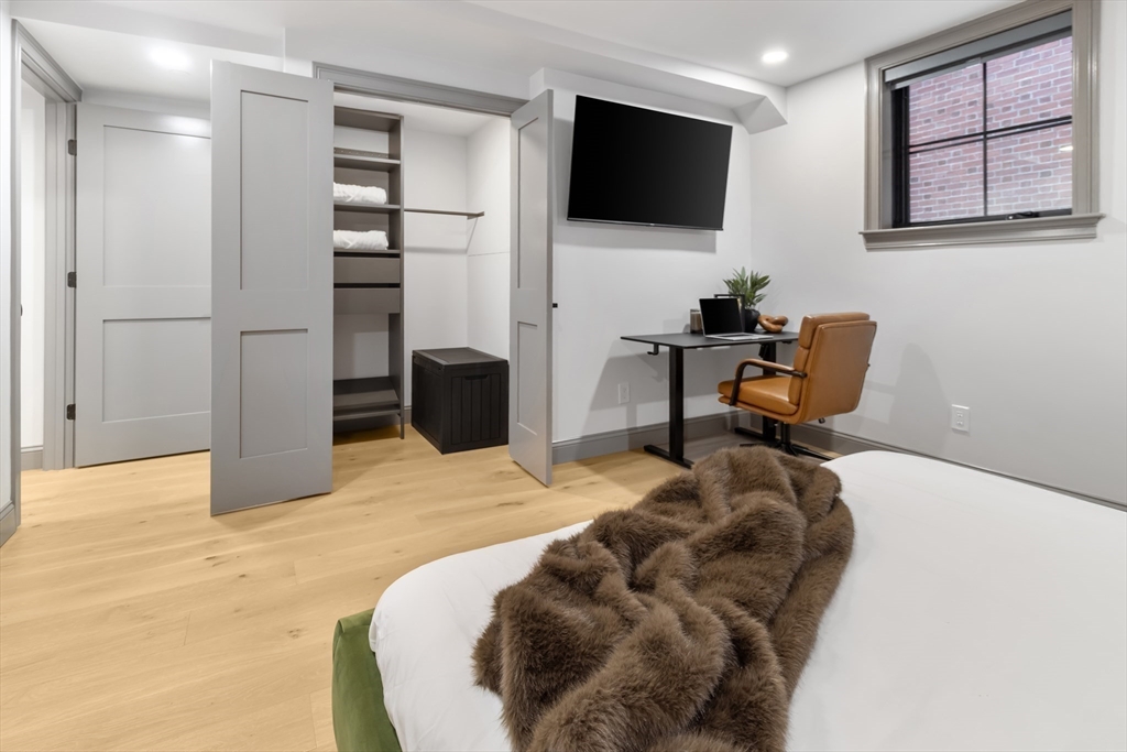 4 Snelling Place, Unit 4 Boston, MA 02113 - Photo 10 of 15 a bedroom with a bed and a flat screen tv