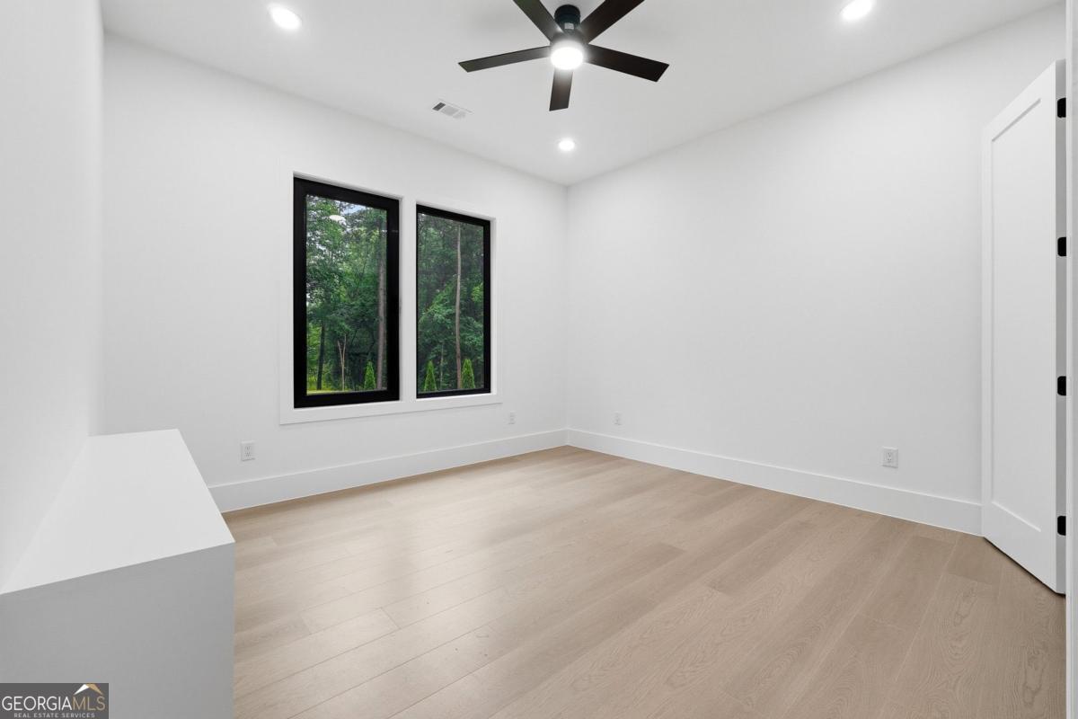 1563 Whitley Road Bethlehem, GA 30620 - Photo 22 of 44 wooden floor in an empty room with a window