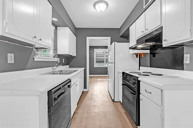 a kitchen with a stove and a sink