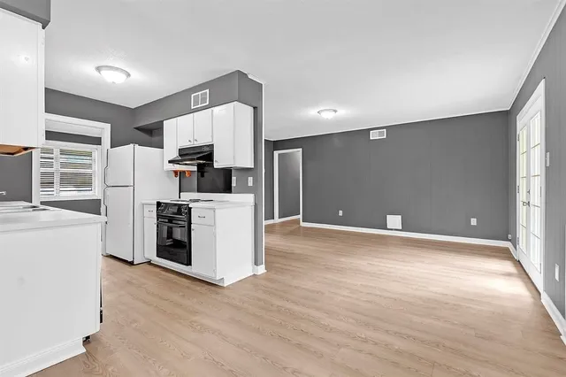 a kitchen with stainless steel appliances a refrigerator and a stove top oven