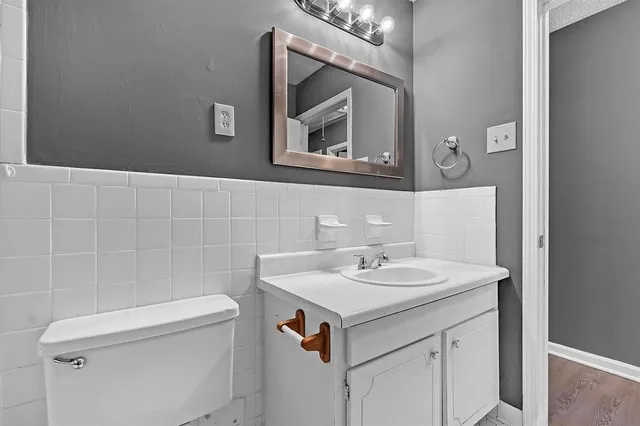 a bathroom with a sink a toilet and mirror