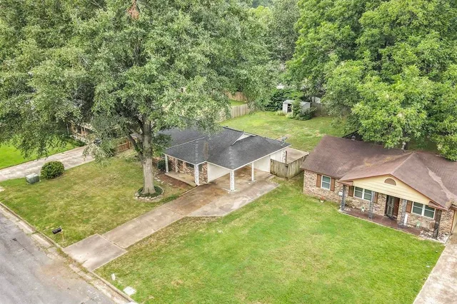 a view of a house with a yard and sitting area