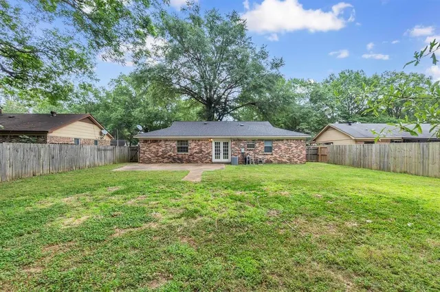 a view of house with backyard and garden