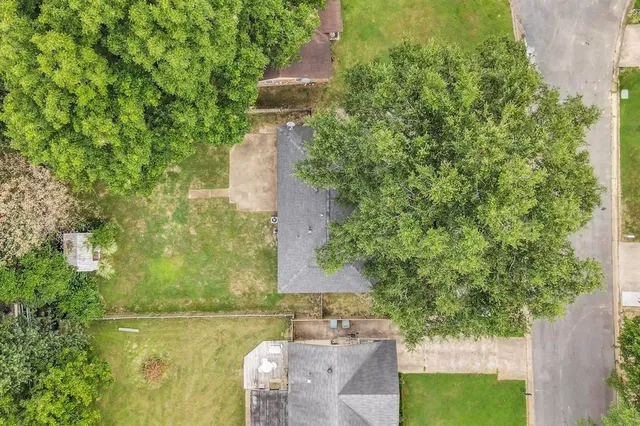 an aerial view of a house with a yard