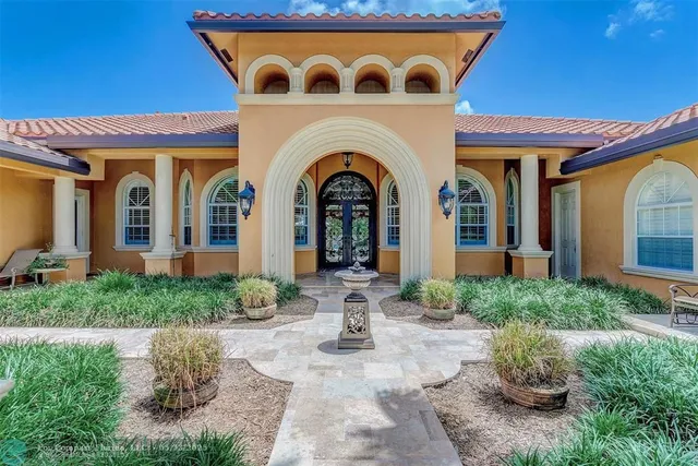a living room with fireplace furniture and a large window
