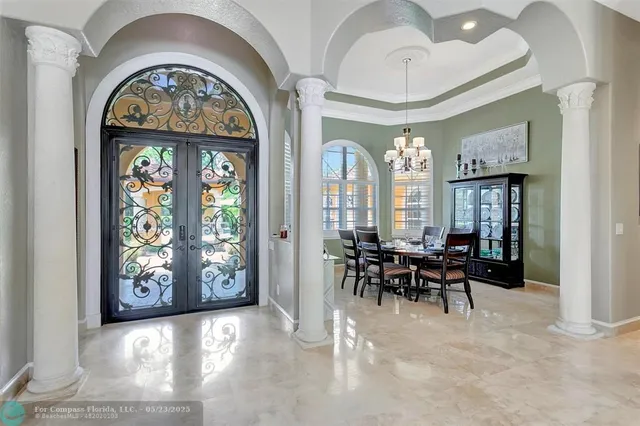 a living room with furniture chandelier and a chandelier